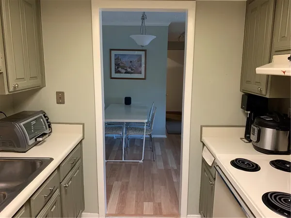a view of a hallway with wooden floor and closet