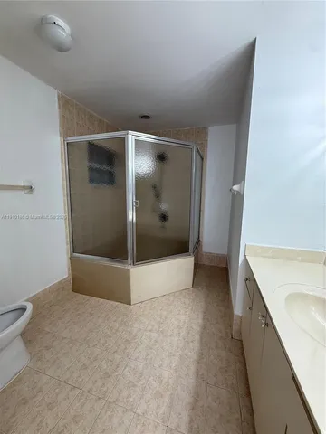 a view of a bathroom with a tub and mirror