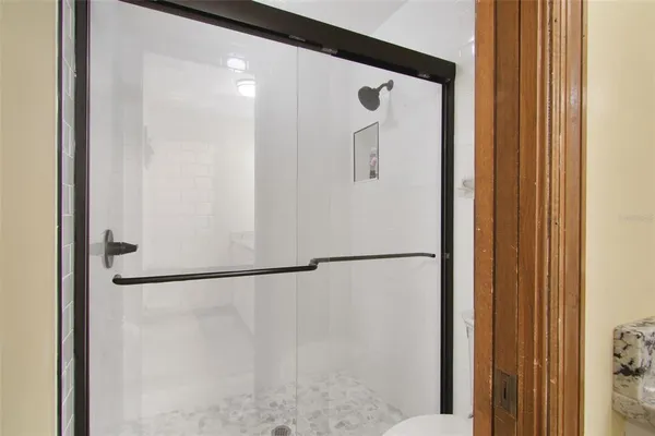 a white glass door and shower door