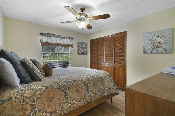 a bed sitting in a bedroom next to a window