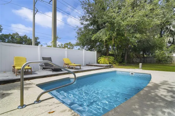 a view of swimming pool with chairs