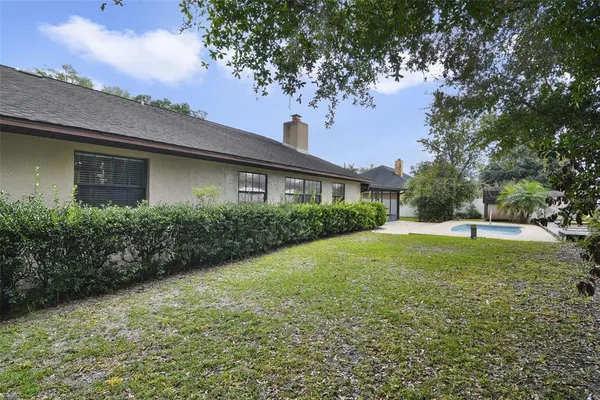 a view of a house with a backyard