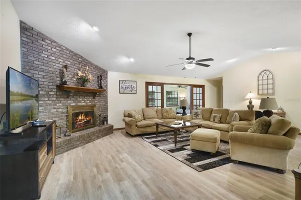a living room with furniture flat screen tv and a fireplace