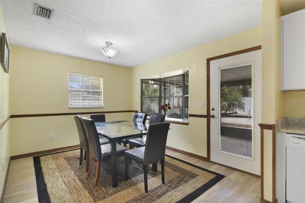 a view of a dining room with furniture and window