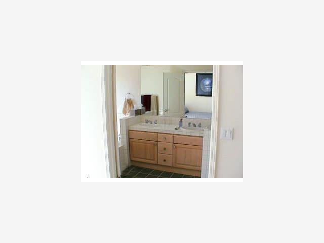 988 Alpine Terrace, Unit 5 Sunnyvale, CA 94086 - Photo 7 of 9 a bathroom with a sink a vanity and a mirror