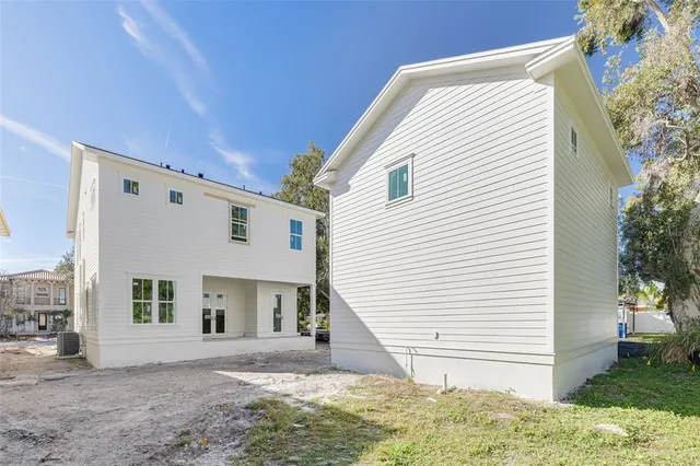a view of a white house with a yard and garage