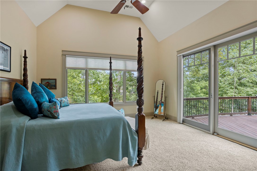 117 Sunrise Ridge Sunset, SC 29685 - Photo 12 of 44 A spacious bedroom retreat offers vaulted ceilings and direct deck access, inviting natural light.