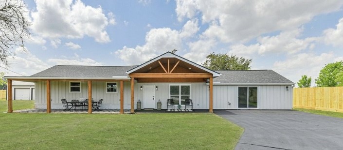 a front view of a house with swimming pool having outdoor seating