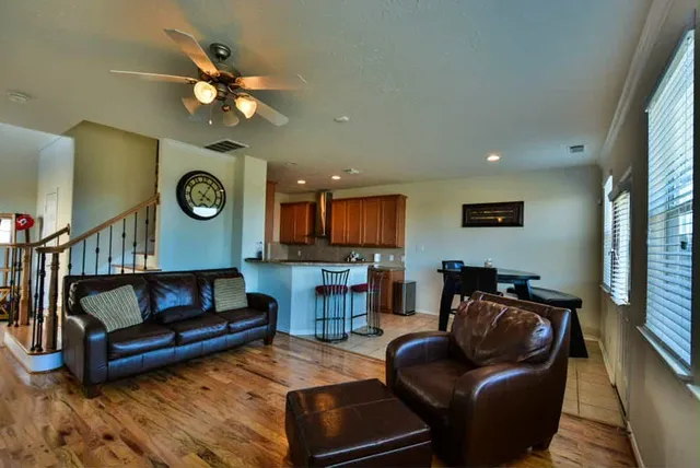 a living room with furniture a flat screen tv and a fireplace