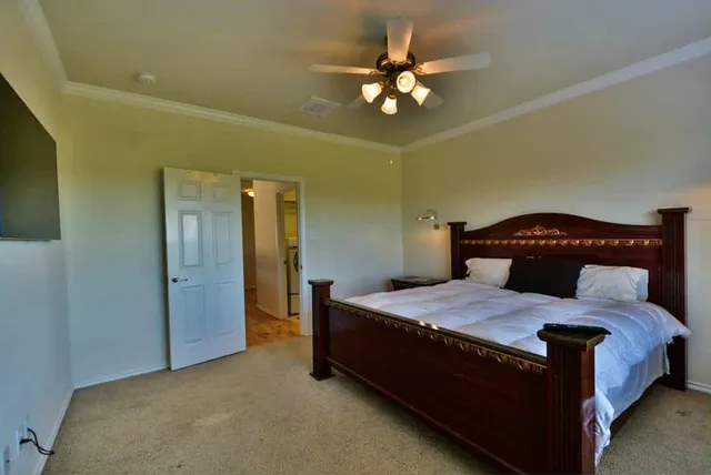 a bedroom with a bed and a chandelier