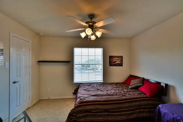 a bedroom with a bed and a chandelier