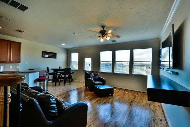 a living room with furniture and large windows