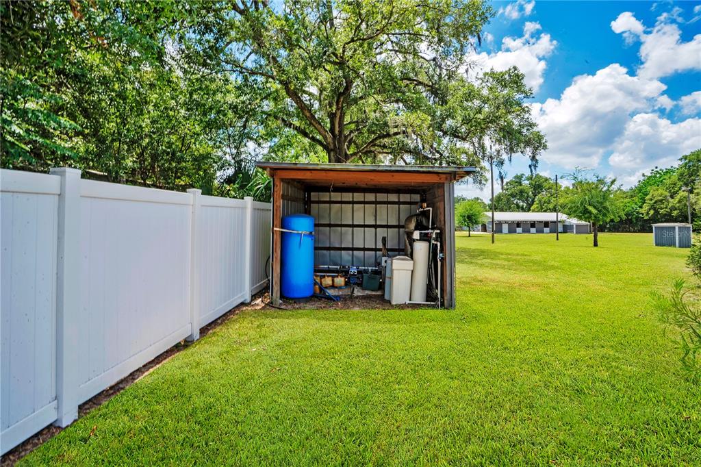 5785 Gilliam Road Orlando, FL 32818 - Photo 85 of 100 a view of a house with backyard and a tree