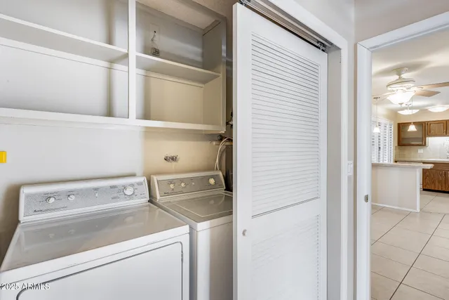 a view of washer and dryer with kitchen in the background