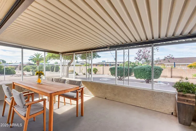 a dining room with stainless steel appliances granite countertop furniture and a garden