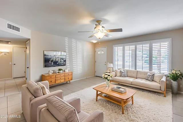 a living room with furniture and a large window