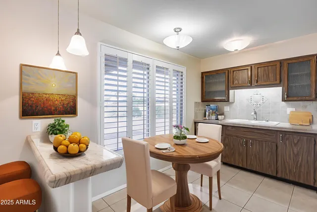 a kitchen that has a table and chairs in it