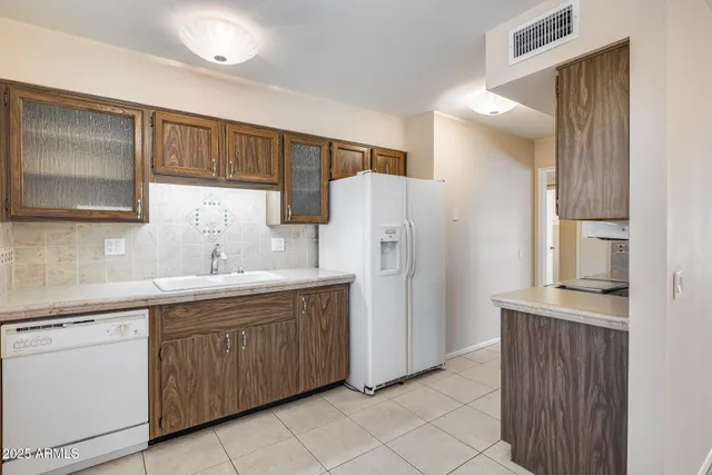 a kitchen with a sink and refrigerator