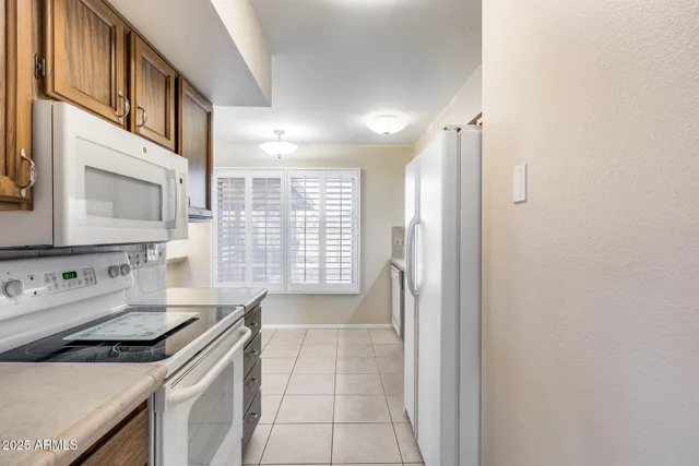 a kitchen with a stove a sink and a refrigerator
