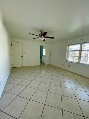 a view of an empty room and a window