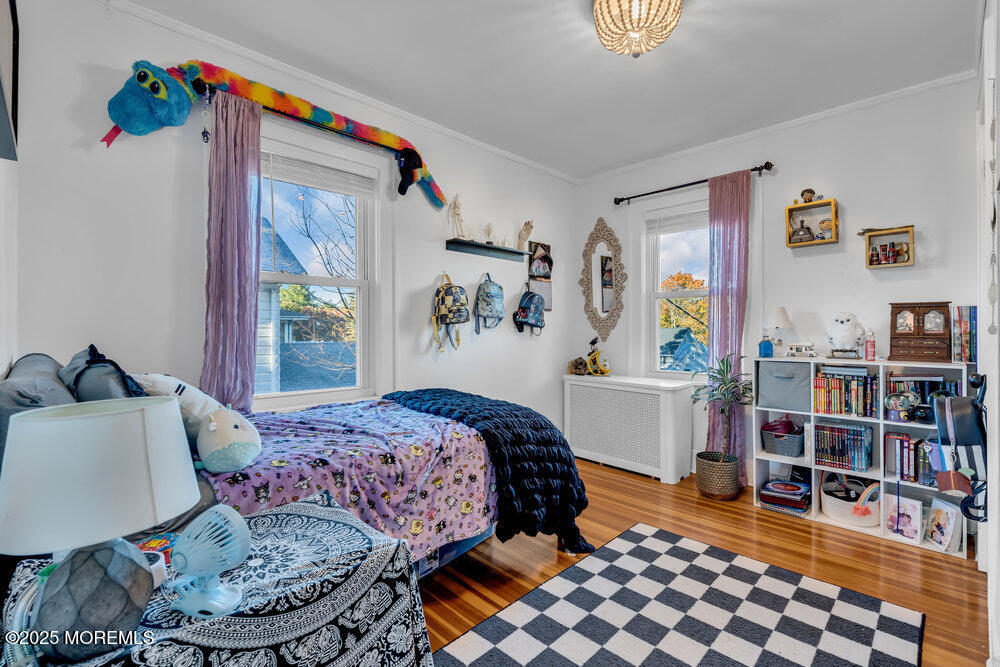 22 Statesir Place Red Bank, NJ 07701 - Photo 17 of 34 a bedroom with furniture and a book shelf