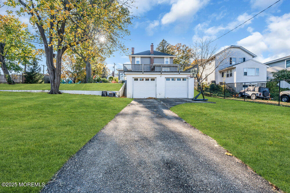 22 Statesir Place Red Bank, NJ 07701 - Photo 27 of 34 a view of a white house in front of a big yard with plants and large trees