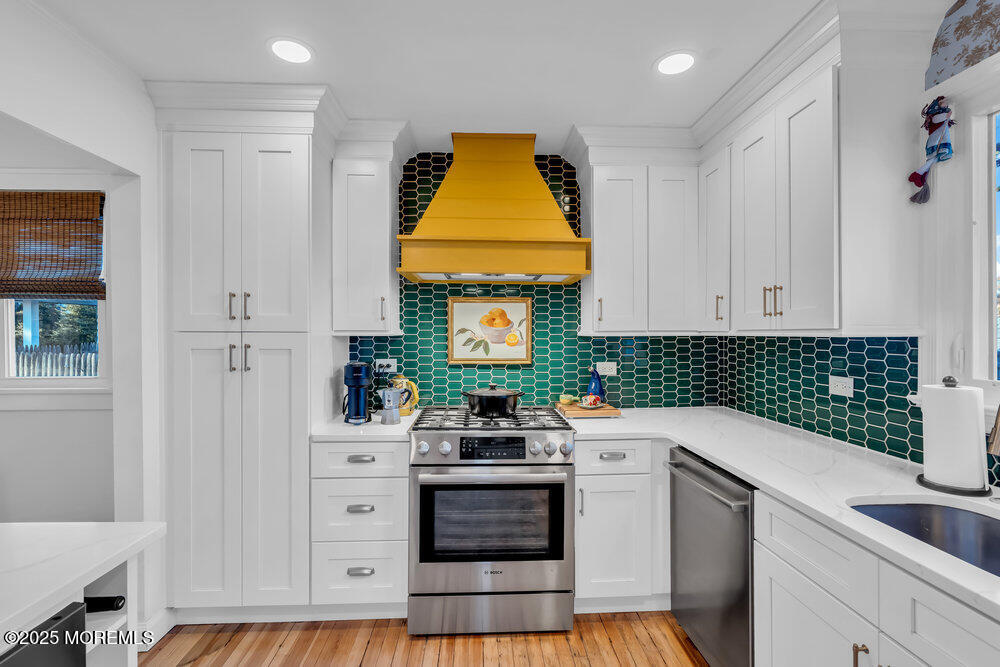 22 Statesir Place Red Bank, NJ 07701 - Photo 6 of 34 a kitchen with white cabinets and appliances