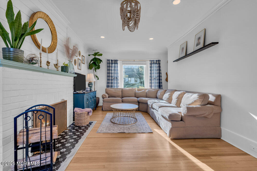 22 Statesir Place Red Bank, NJ 07701 - Photo 10 of 34 a living room with furniture a chandelier and a rug