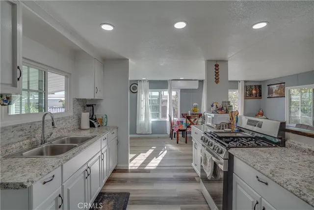 a kitchen with sink stove and cabinets