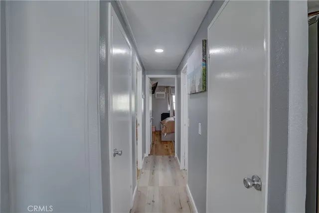 a view of hallway with wooden floor
