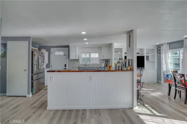 a large kitchen with stainless steel appliances a refrigerator and a stove top oven