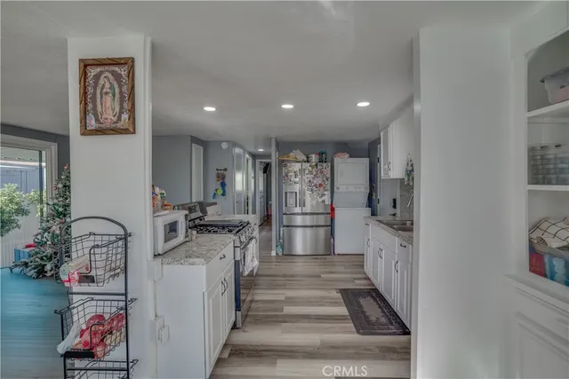 a view of a room with lots of stuff and hardwood floor