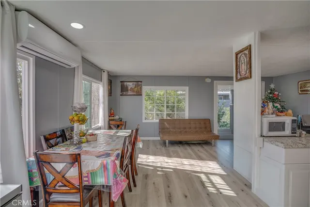a dining room with furniture and a window
