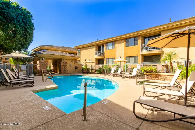 a view of a patio with swimming pool table and chairs