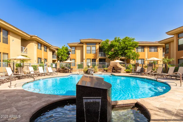 a view of a swimming pool with outdoor seating