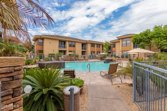 a view of a chairs and table in the patio in front of house