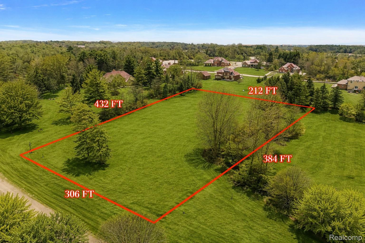 8267 Sandi Lane Romeo, MI 48065 - Photo 2 of 46 Expansive lot featuring a vibrant green lawn, mature trees, and defined property boundaries