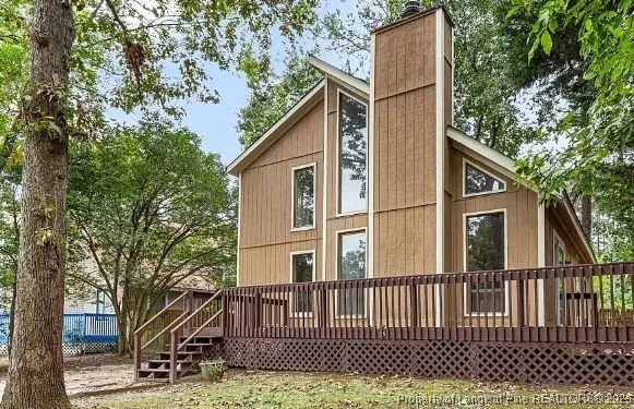 a view of a house with a small yard and wooden fence