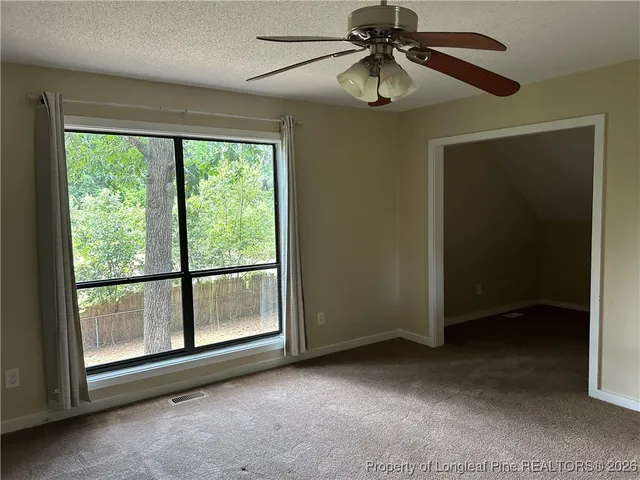 a view of room with window and ceiling fan