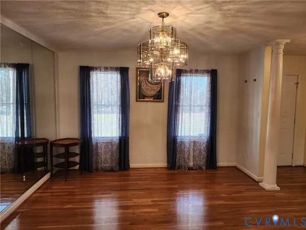 a view of a livingroom with wooden floor and windows