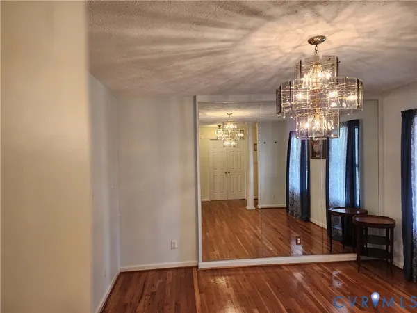 a view of a room with wooden floor