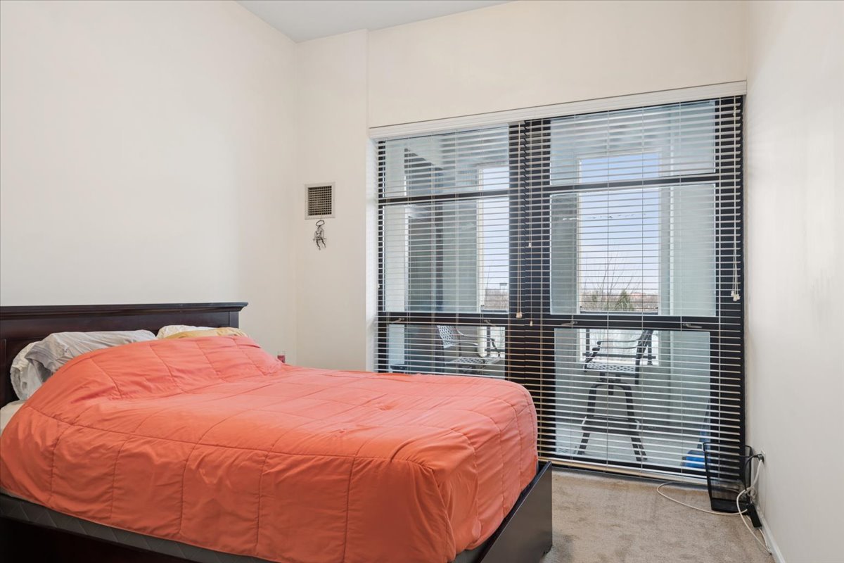 1255 South State Street, Unit 502 Chicago, IL 60605 - Photo 6 of 13 a bedroom with a bed and a window