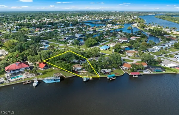 an aerial view of a house with a yard and garden