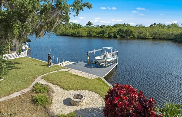 an aerial view of a residential houses with outdoor space and lake view