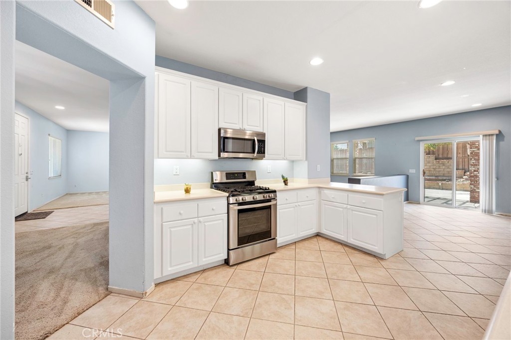 151 Ropango Way Hemet, CA 92545 - Photo 10 of 28 a kitchen with a sink a counter top space appliances and cabinets