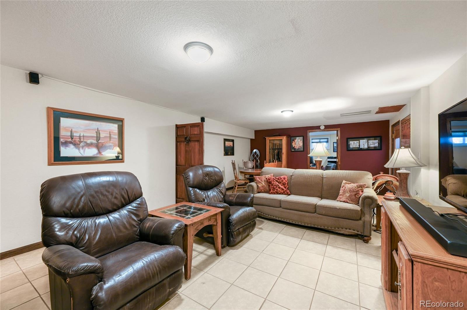 5430 Murr Road Peyton, CO 80831 - Photo 41 of 50 a living room with furniture and a flat screen tv