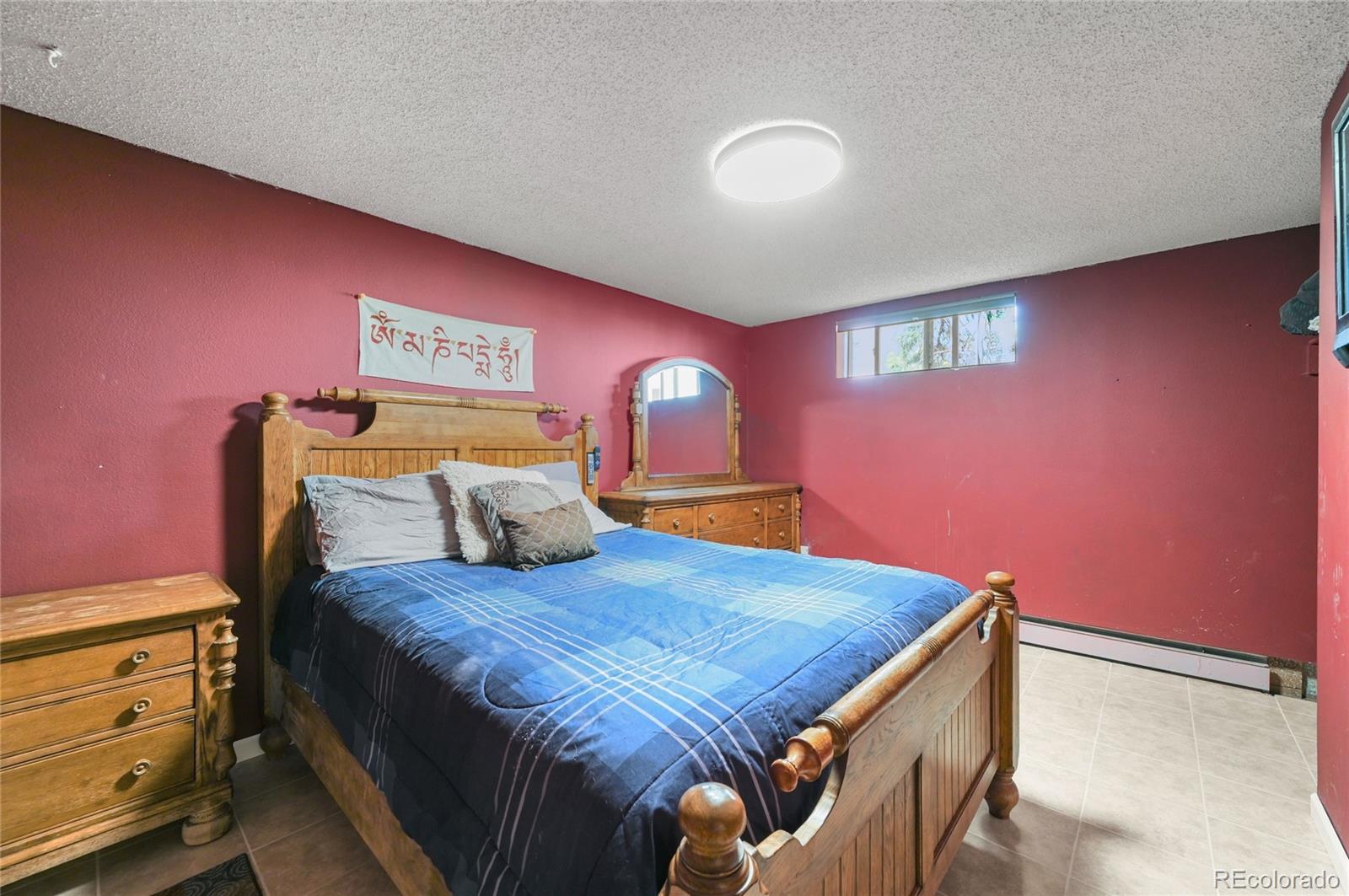 5430 Murr Road Peyton, CO 80831 - Photo 46 of 50 a bedroom with a bed and dresser