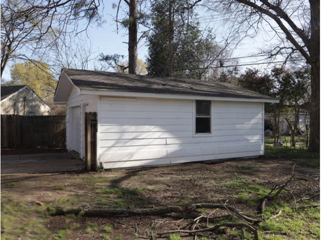 1180 Russwood Road Memphis, TN 38122 - Photo 5 of 5 Detached garage with white siding, a window, and a dark shingle roof
