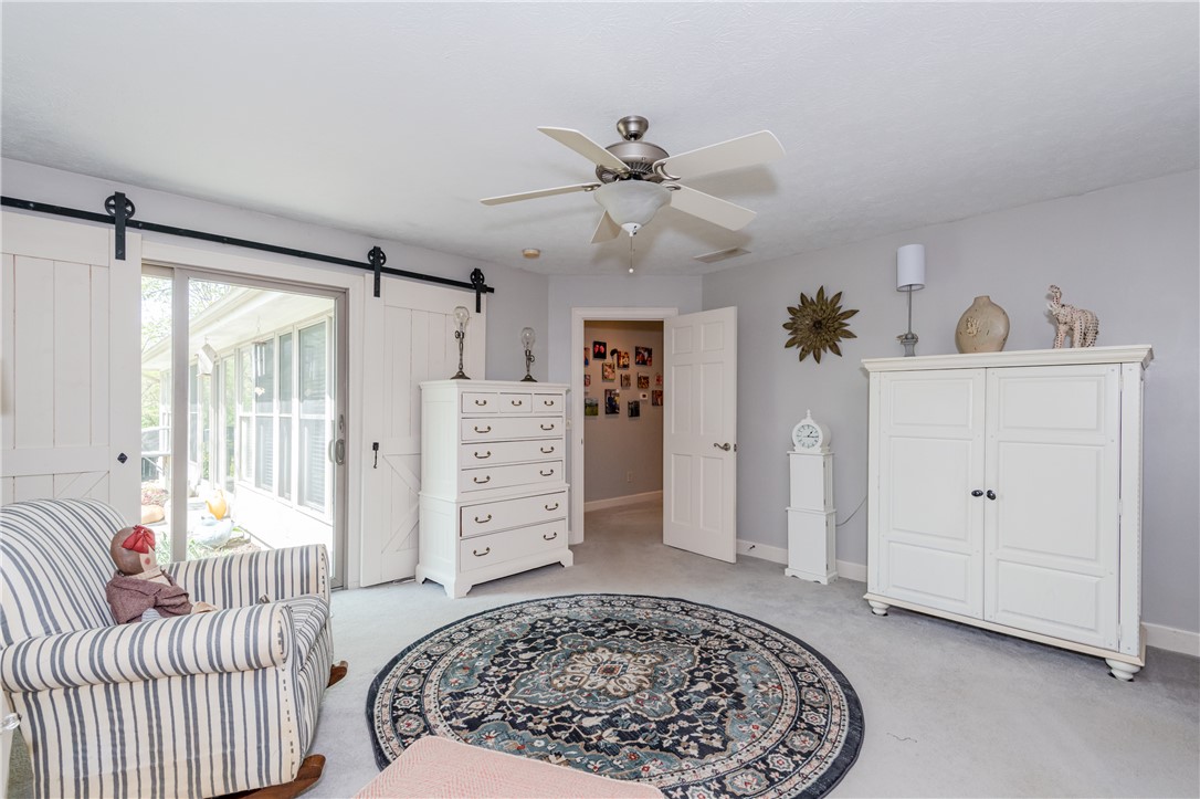 159 East Lytle 5 Points Road Springboro, OH 45066 - Photo 26 of 45 This spacious room features a ceiling fan, plush carpet, and a sliding glass door leading to an outdoor area.