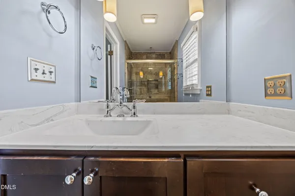 a room with a sink and a mirror